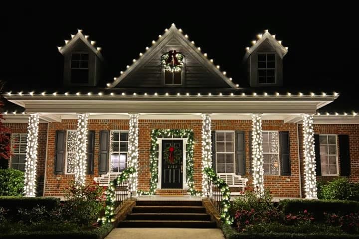 Holiday lights decorating a home and its outdoor spaces