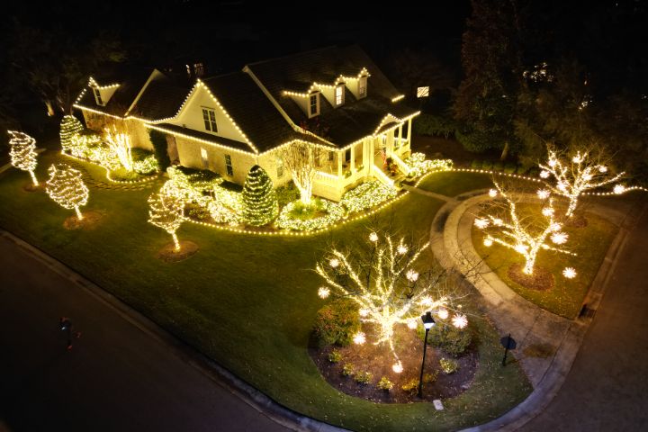 A home illuminated with warm white holiday lights