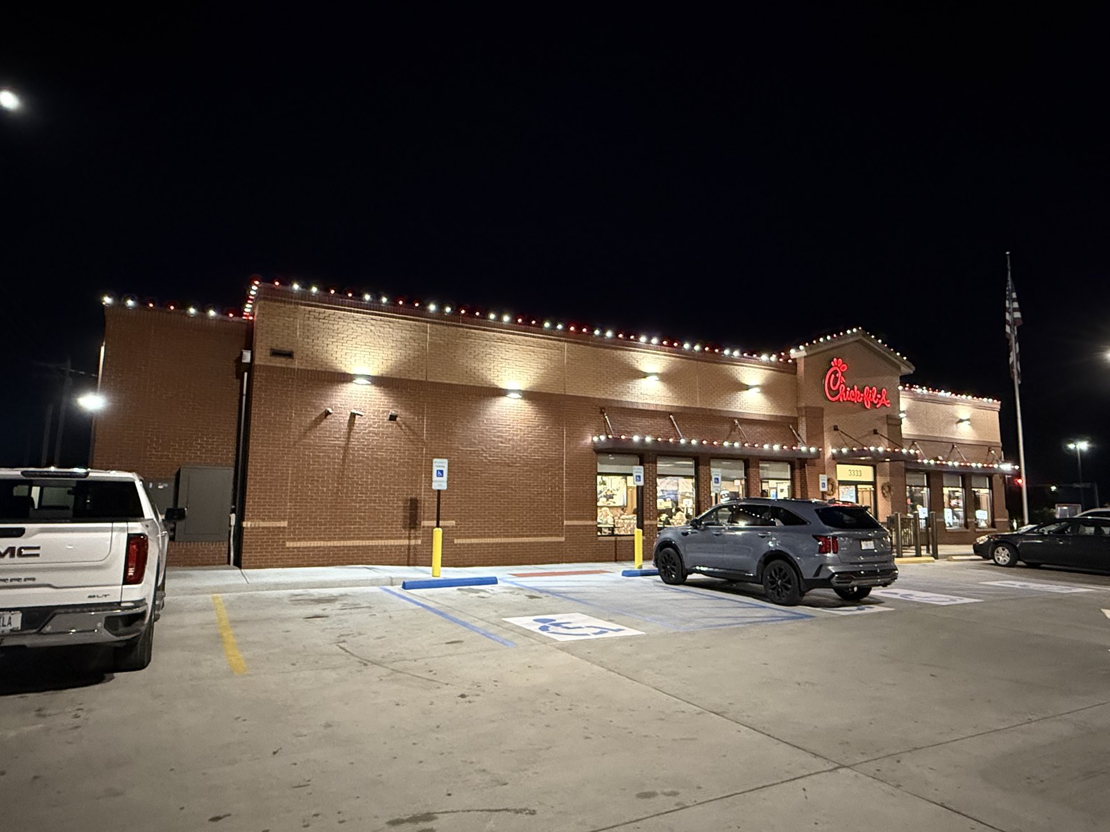Holiday lights along a Chick-fil-A restaurant roofline