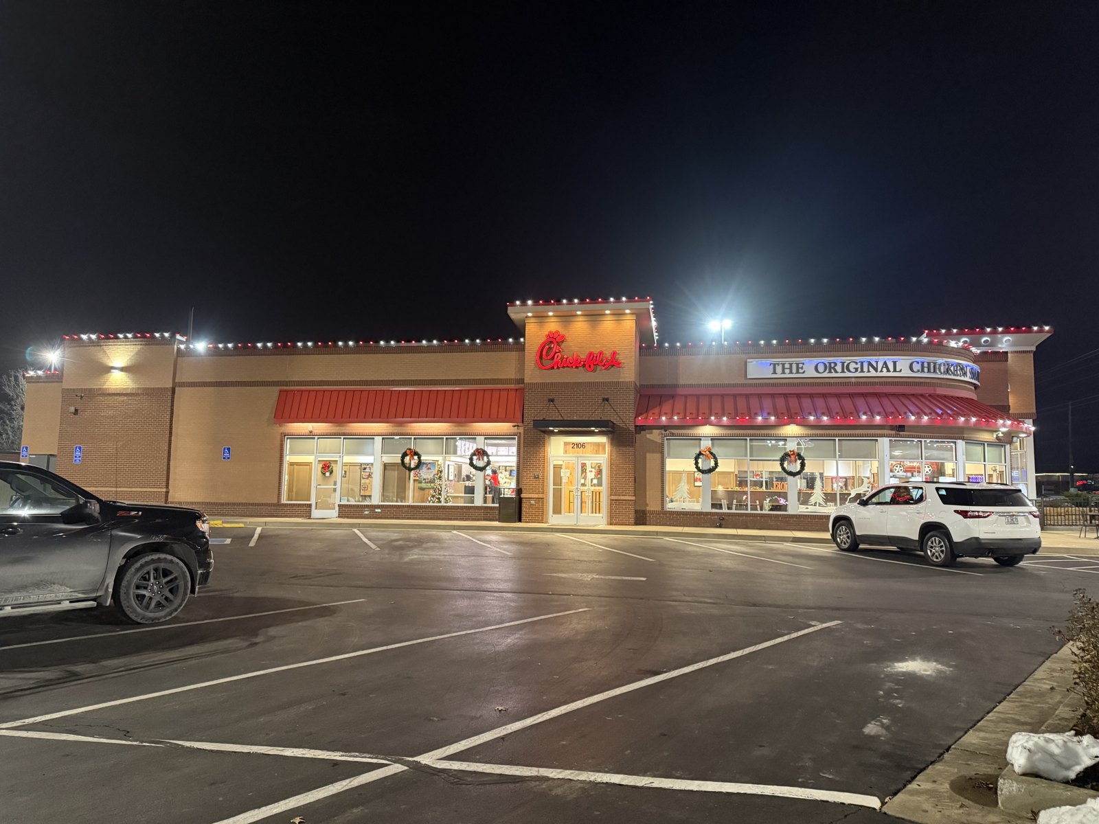 Christmas lighting on a Chick-fil-A restaurant at night