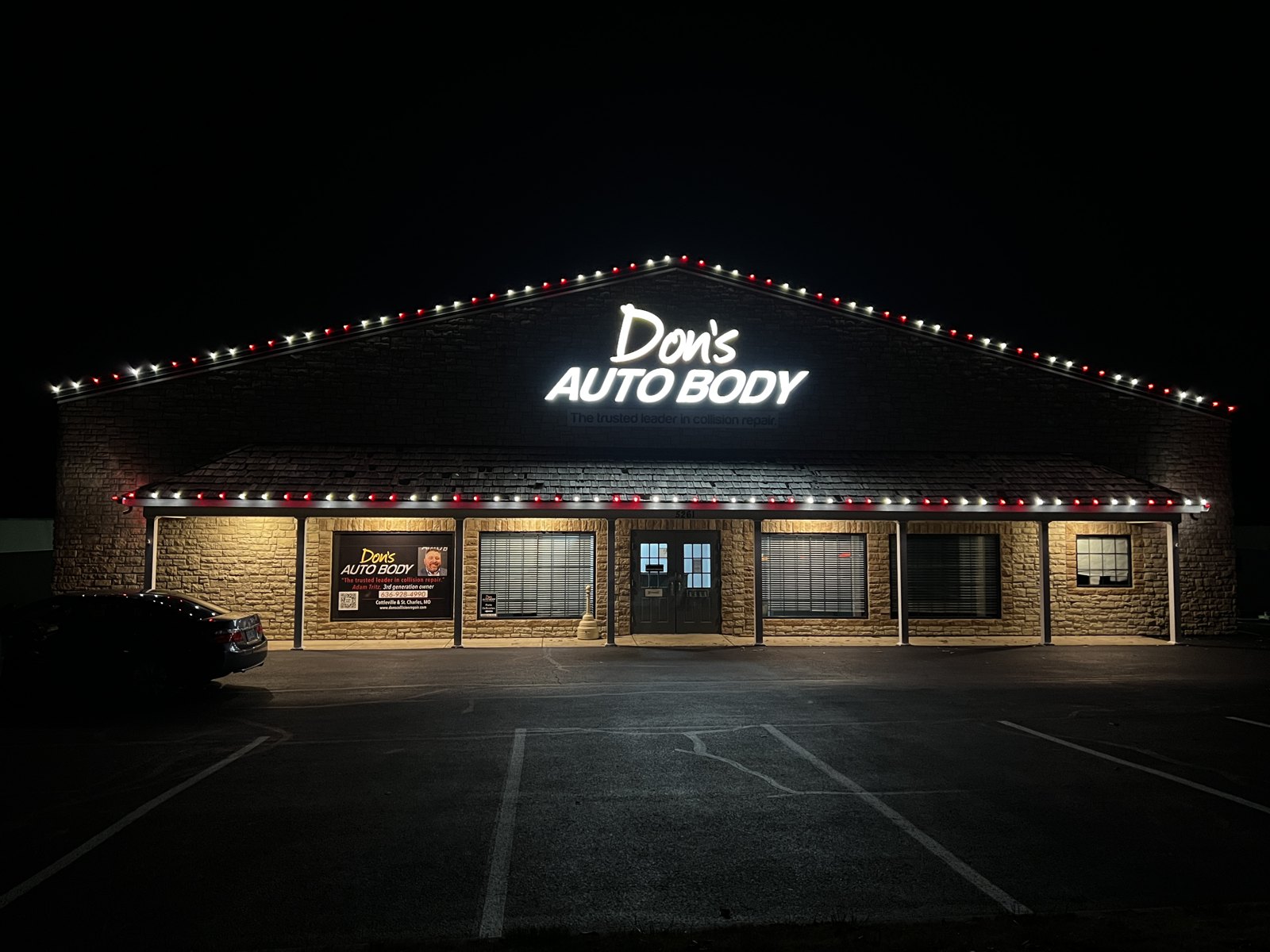 Holiday roofline lighting at a commercial storefront